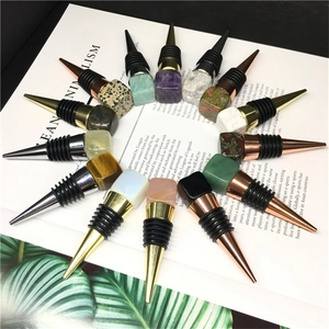 Natural crystal cube wine stoppers in assorted colors arranged on an open magazine