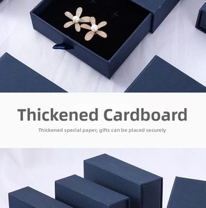 Close-up of pearl flower earrings inside a premium navy blue drawer jewelry box