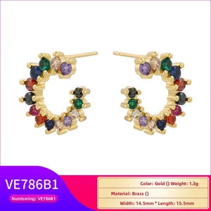 Macro detail of 18K gold plated C-shaped earrings with vibrant rainbow cubic zirconia