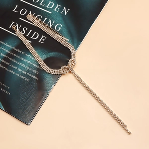 Detail of multi-row gold choker with sparkling crystal rhinestones and tassel design