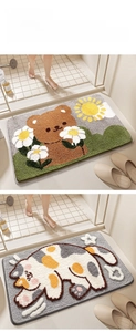 Close-up of plush cartoon bear and cat bathroom mats with non-slip texture