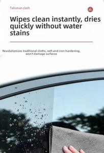 Detail showing high-absorbent microfiber cloth wiping a wet car glass surface clearly