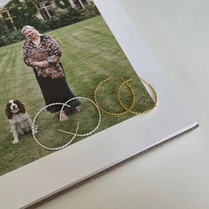 Close-up of twisted rope hoop earrings in gold and silver finish on a magazine