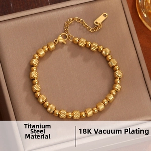 Close-up of 18K vacuum plated titanium steel bracelet with textured beads and lobster clasp