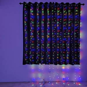 Detail view of multicolored RGB LED curtain fairy lights hanging on a dark fabric background