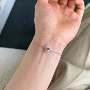 Close-up of pink heart zircon tennis bracelet in S925 sterling silver on woman wrist