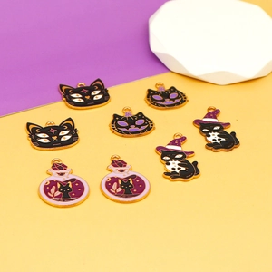 Detail of eight assorted Halloween black cat enamel charms in purple and gold colors