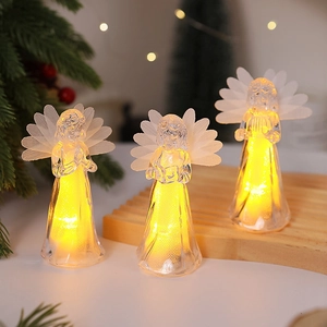 Macro detail of lighted crystal acrylic angels with warm LED glow and feather wings