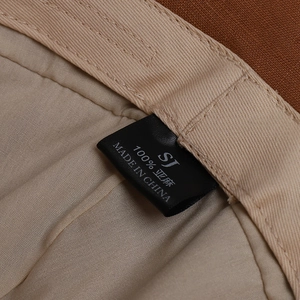 Detailed view of the internal label on a 100% linen bucket hat showing fabric