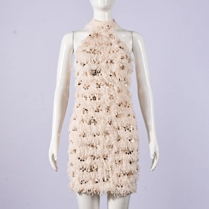 Detailaufnahme des champagnerfarbenen Paillettenkleids mit Federsaum und Neckholder