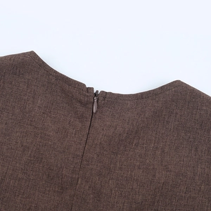 Detail of the back neckline featuring a brown dress with a hidden zipper closure