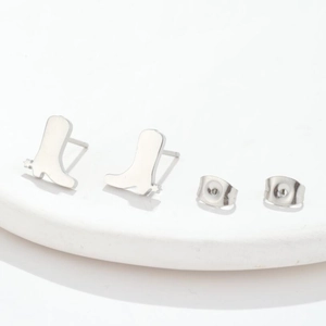 Minimalist silver boot shaped stainless steel stud earrings on white background