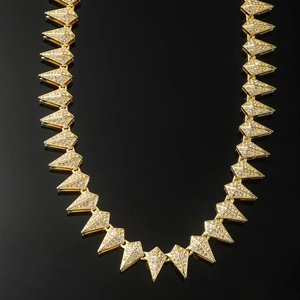 Hip hop gold teardrop geometric necklace with full diamonds on a reflective background