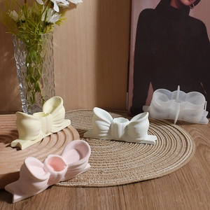 Detailed view of DIY bow resin molds and finished plaster bases in assorted pastel colors