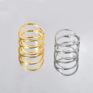 Detail view of double cross hollow rings in gold and silver finish on a mirror surface