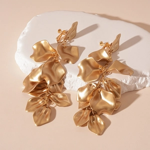 Detail of golden long tassel petal earrings with screw-back clips for non-pierced ears