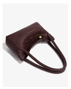 Detail of coffee brown woven tote bag featuring a knotted handle with a gold metal ball accent