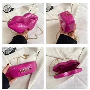 Detailed views of magenta lip-shaped acrylic clutch with gold metal chain strap