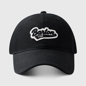 Detail of embroidered Barton 1768 logo on black cotton baseball cap with curved brim