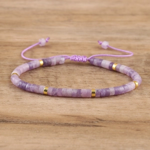 Detail view of purple imperial stone beads and gold spacers on braided adjustable bracelet
