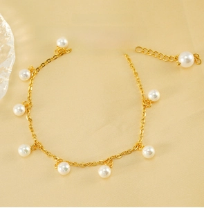 Detail of gold pearl tassel anklet with lobster clasp on silk, adjustable extension chain