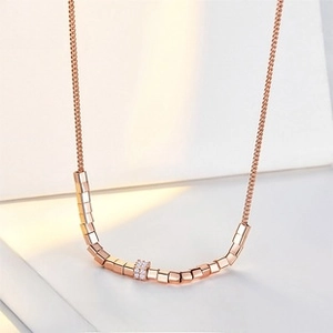 Macro detail of S925 sterling silver sugar cube necklace with rose gold pave zircons