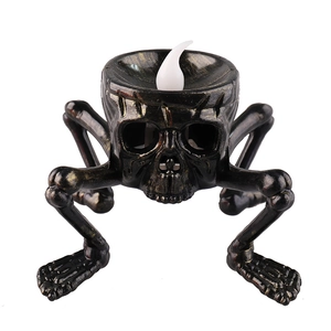 Halloween skeleton hand candle light with LED flame on a vintage bronze skull base