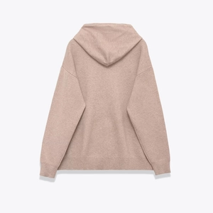 Detail view of the soft pink knitted hoodie showing fine fabric texture and ribbed cuffs