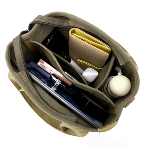 Army green thick canvas tote bag with multi-compartment interior for laptop and essentials