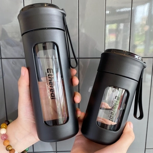 Close-up of two matte black portable water bottles with carrying straps and clear windows