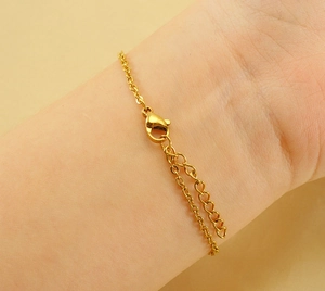 Detail view of the golden titanium steel bracelet clasp and adjustable link chain