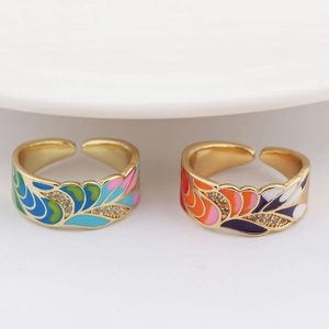 Detailed macro view of peacock feather enamel rings with colorful zircon inlays