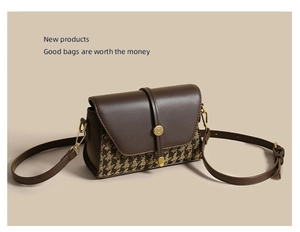 Close-up of retro houndstooth canvas and leather stitching with gold metal buckle