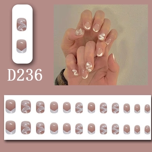 Detail of 24pcs nude pink press-on nails with white V-lines and pearl decorations
