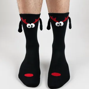 Detail of magnetic Christmas couple socks featuring 3D cartoon deer with red antlers