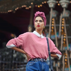 Close-up of a pink pleated turban paired with a pink sweatshirt for a vintage French look