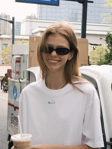 Street style view of white cotton crewneck t-shirt and trendy oval sunglasses