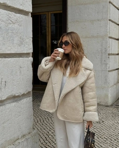 Detail of beige faux suede jacket with shearling lining and classic turn-down collar