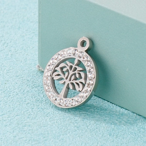 Silver tree of life pendant with sparkling crystal inlay on a blue textured gift box