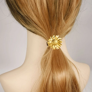Golden sunflower hair tie on ponytail shown from behind on blonde model