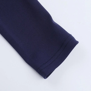 Detailed close-up of dark blue knit sleeve featuring high-quality double-needle stitching