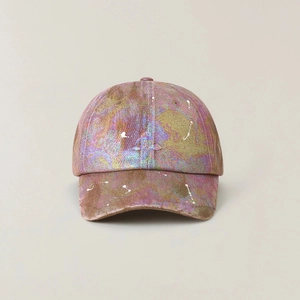 Detail of colorful metallic baseball cap with paint splatter and embroidered cross logo