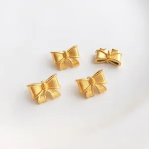 Perline a forma di fiocco in oro opaco per gioielli DIY con finitura satinata