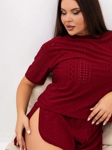 Close-up of wine red hollow eyelet lace fabric and high slit detail on pajama shorts