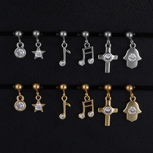 Set of 12 gold and silver surgical steel cartilage studs with crystal charms on display