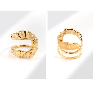 Detailed macro view of golden irregular pleated wave ring with high-gloss metallic finish