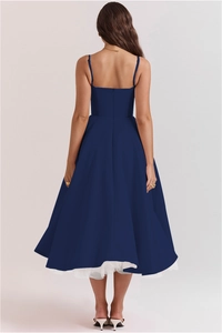 Detail view of the back cut and double-layered mesh petticoat of this navy gown