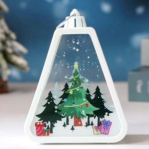 Close-up of a white triangular Christmas lantern with festive tree and snowflake patterns