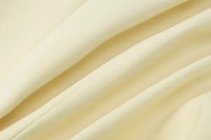 Macro view of beige suit fabric showing dense texture and elegant drape quality