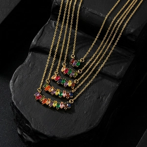 Detailed macro of five layered gold necklaces with vibrant marquise cut zircon stones